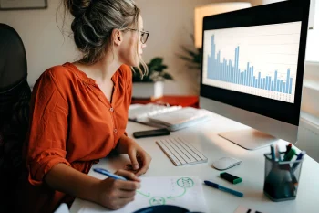 Female researcher working on a computer in a home office