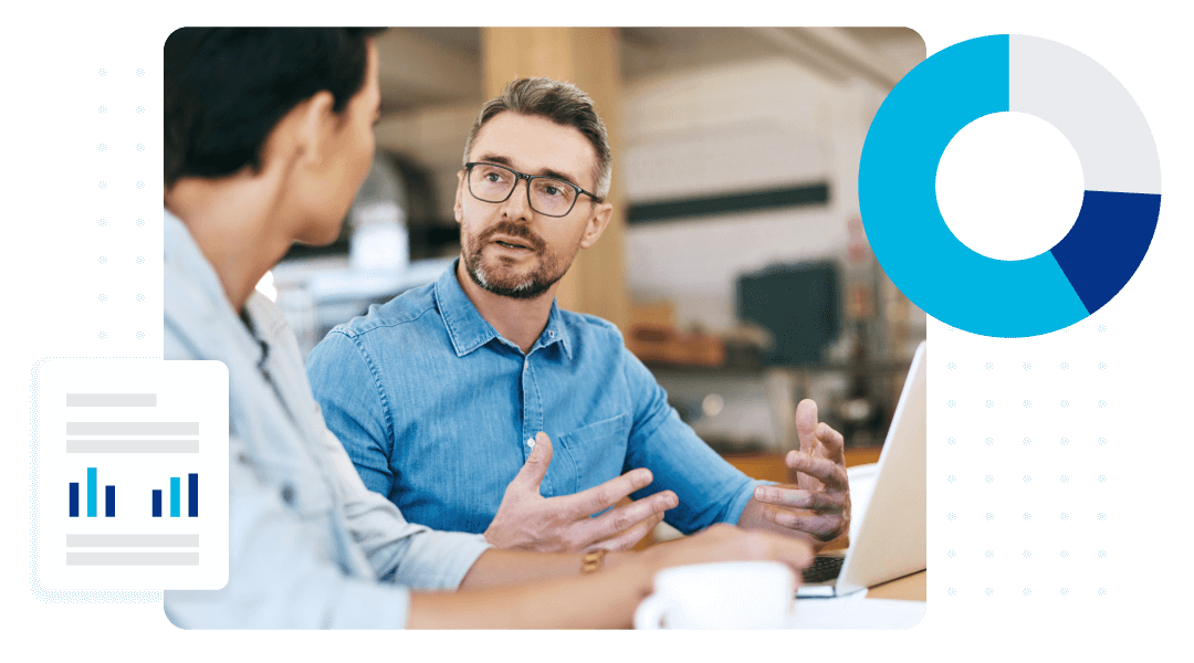 Male and female business owners in discussion at a desk.